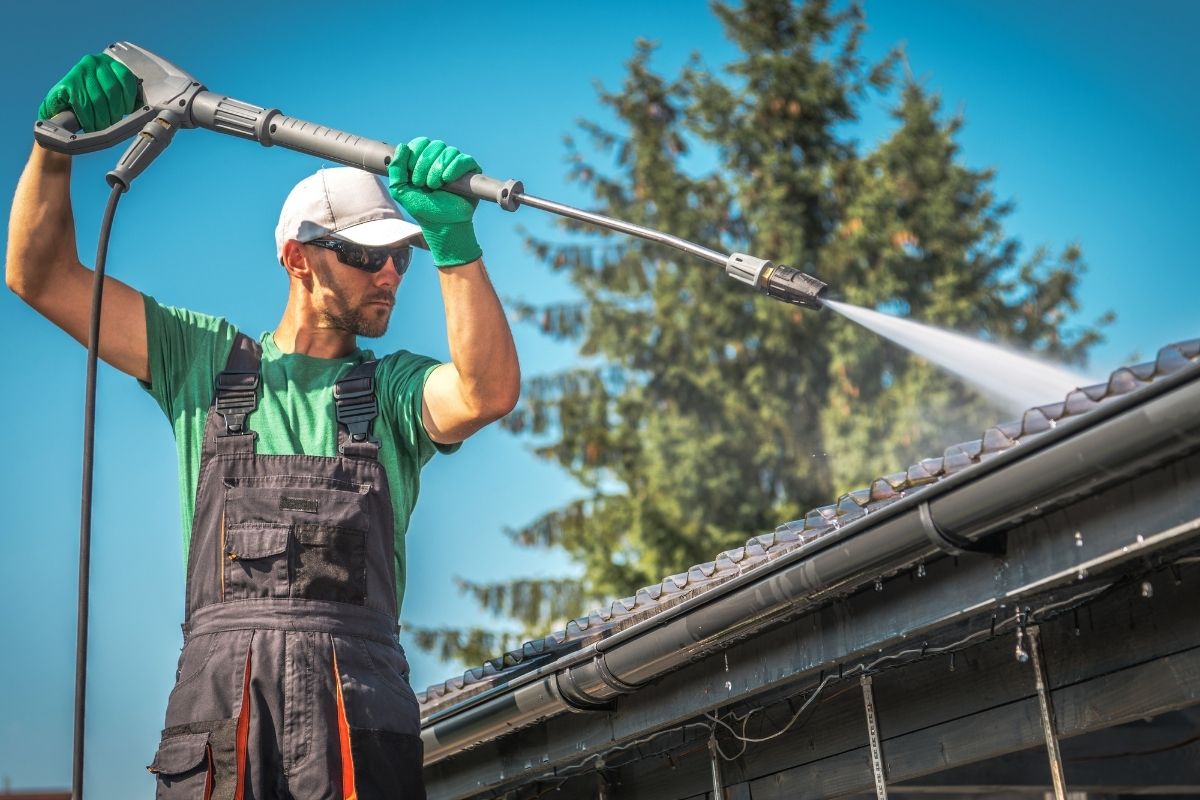 Cleaning gutters with pressure washer